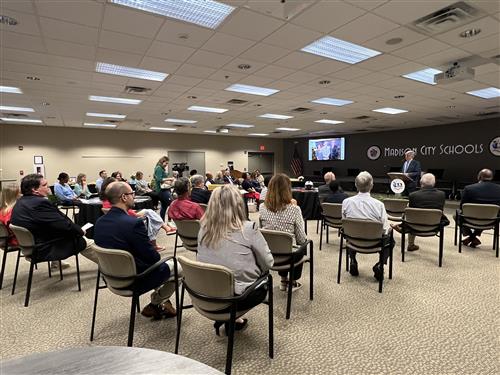 wide angle view of crowd sitting in Board room